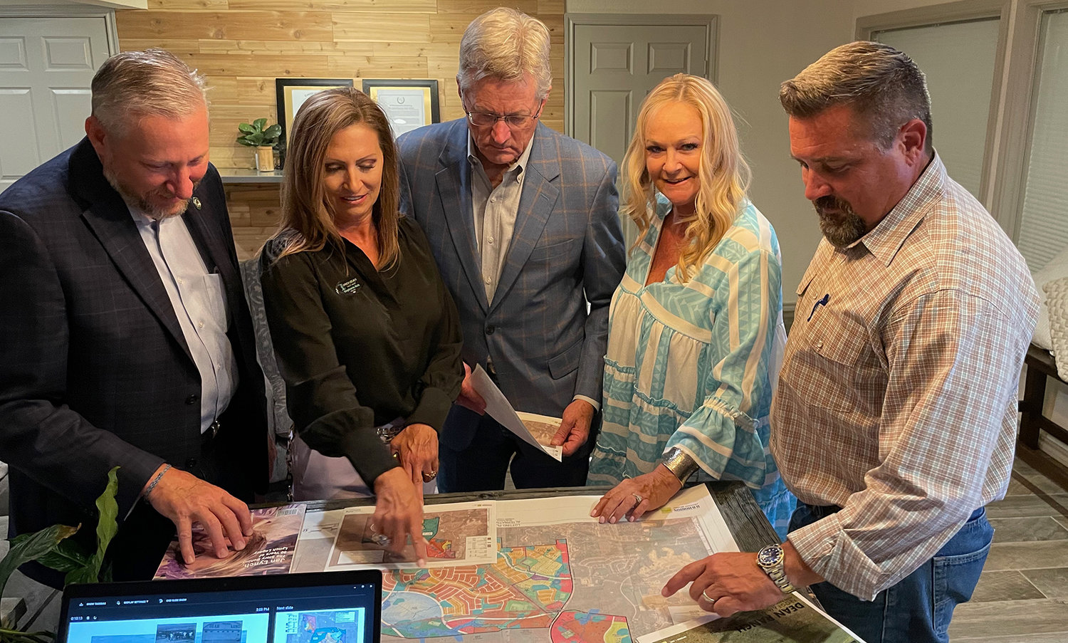 State Senator Drew Springer, Stephanie Rich, State Representative Glenn Rogers, Stacy Lynch, and County Commissioner-elect Mike Hale look over a layout of the plans for the Dean Ranch property.