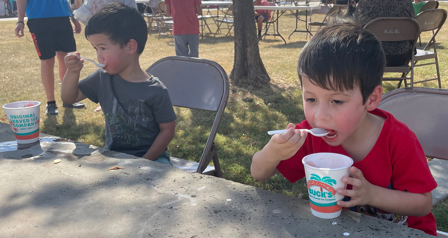 Noah and Matthew Gregory enjoy shaved ice.