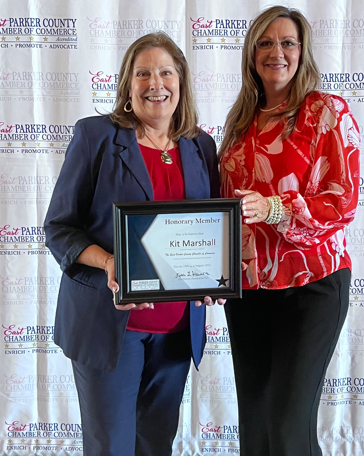 East Parker County Chamber of Commerce President Lisa Flowers (right) presents the chamber's first honorary membership to Kit Marshall.