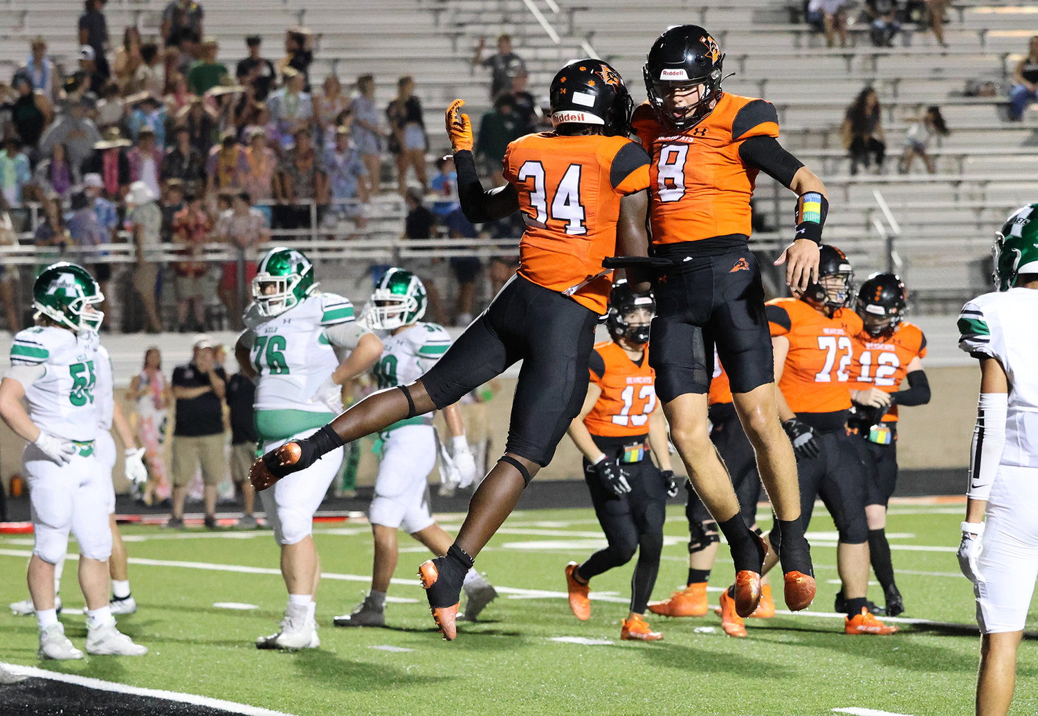 Hauss Hejny and Caleb Pope celebrate following a touchdown.