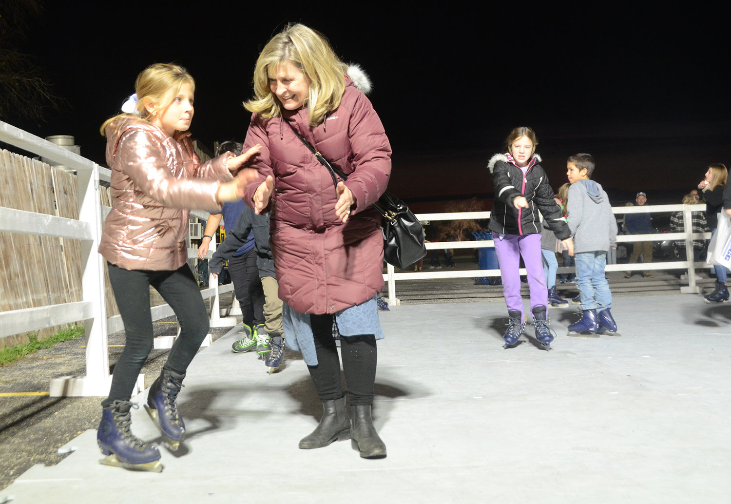Madelyn Benjamin gets help and encouragement on the skating rink from grandmother Jane Phillips.