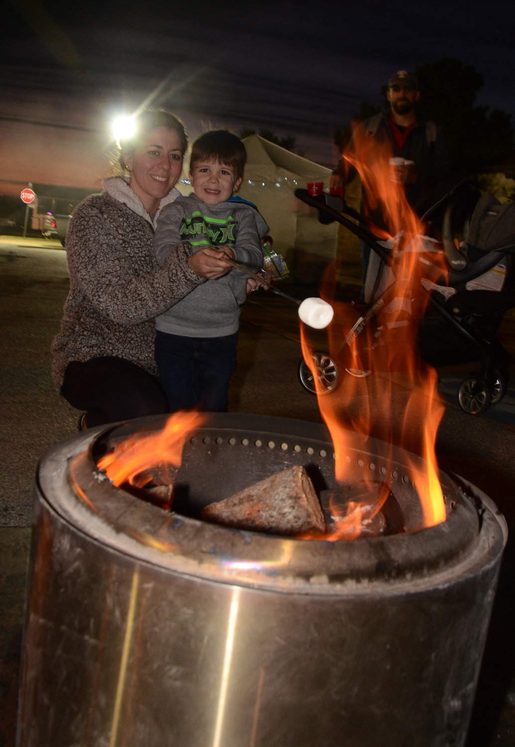 Rowan Lapenna roasts a marshmallow with the help of mother, Tiffany Lapenna.