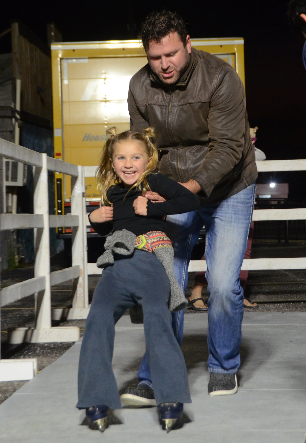 Aaron Gilbreath steadies daughter Presley for her first try at  ice skating.
