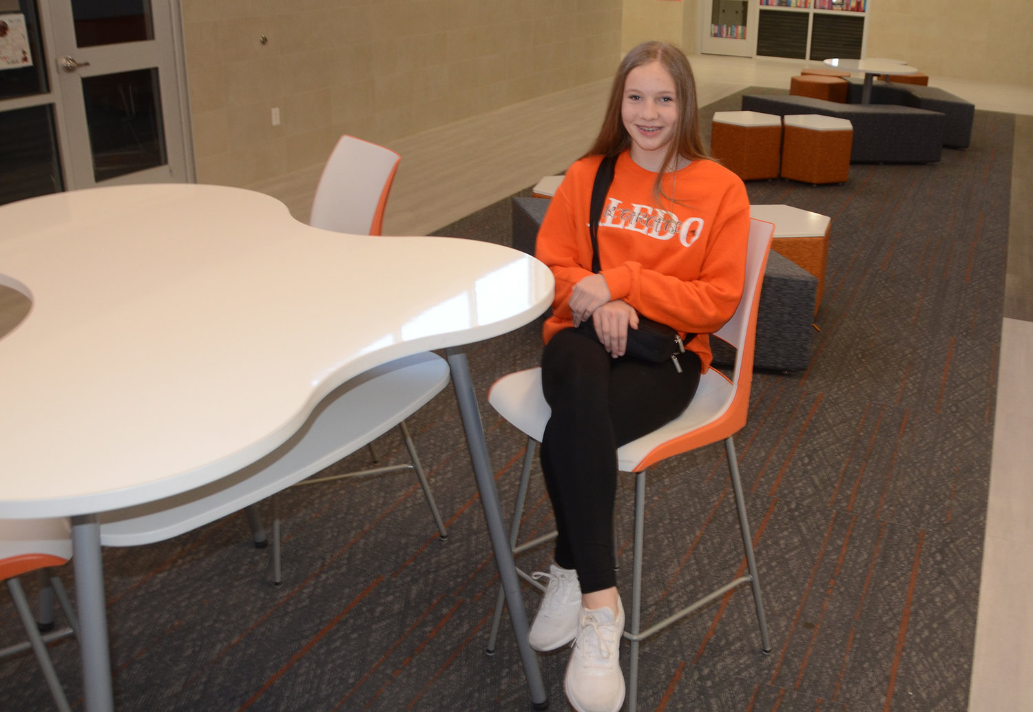 Eighth-grader Addison Eldridge relaxes in one of the collaboration areas of the campus. The hallway lounges are conducive to study and brain-storming with comfortable seating and white marker boards on the walls.