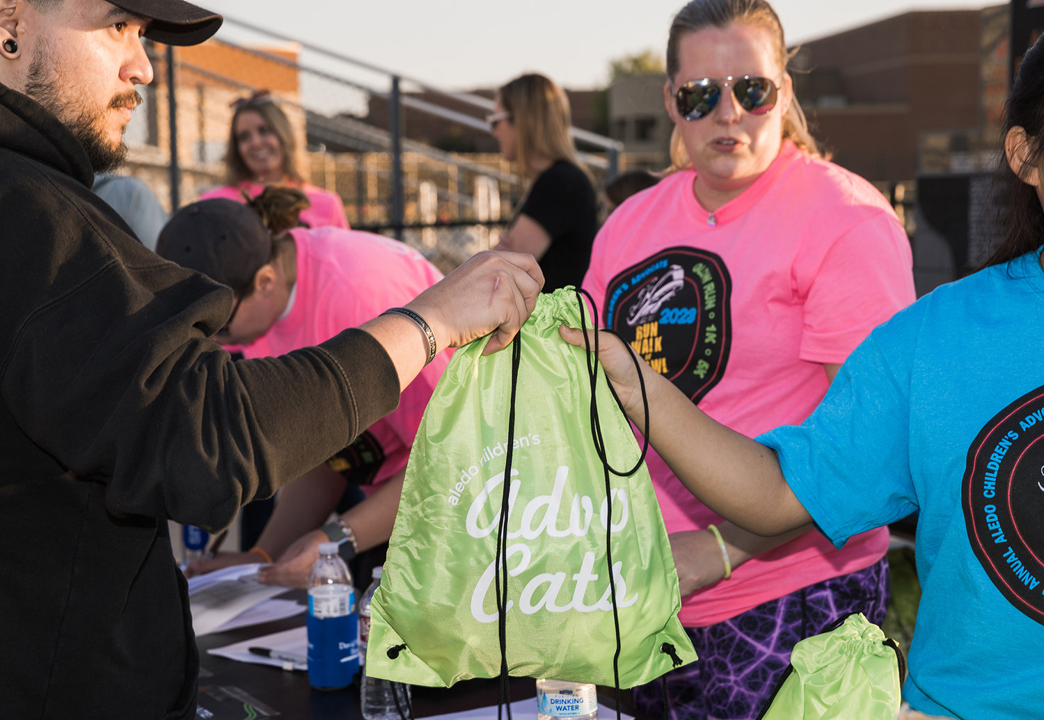 Runners receive backpacks at the registration table.