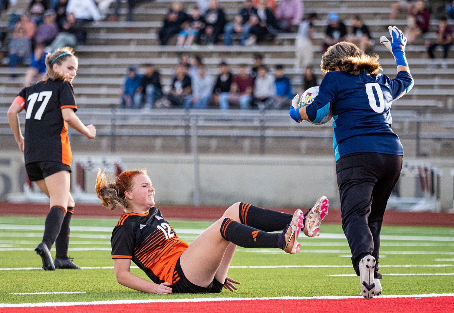Katie Cox gets knocked down by the Northside goalkeeper while attempting to put a shot on goal during bi-district action on Friday, March 24.
