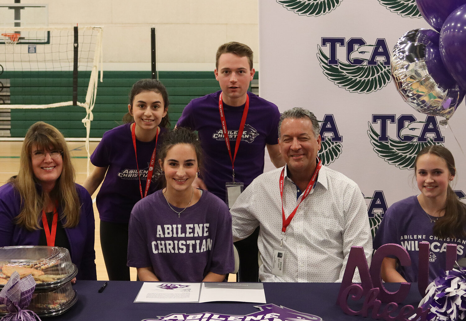 Olivia Vajdos, surrounded by family, signed to be on the cheer squad at Abilene Christian University.