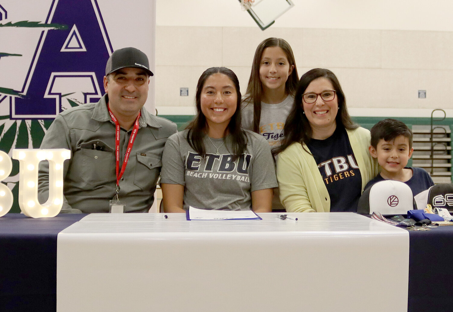 Dora Sagala, surrounded by family, signed to play beach volleyball at East Texas Baptist University.