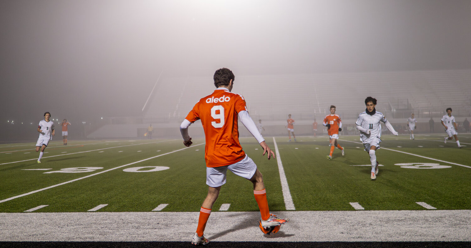 With the fog bearing down, Harrison Hobbs dribbles the ball as a pair of Benbrook defenders close in.