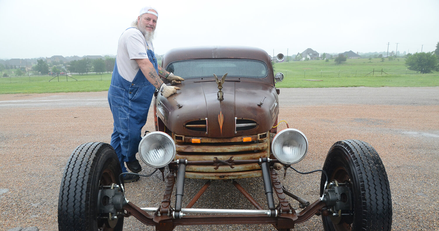 Ronnie Vaughn’s pride and joy is a 1949 Ford F1 jalopy featuring a rusted body, flag pole eagle on a water spigot hood ornament, and a two foot extension of the front axle.