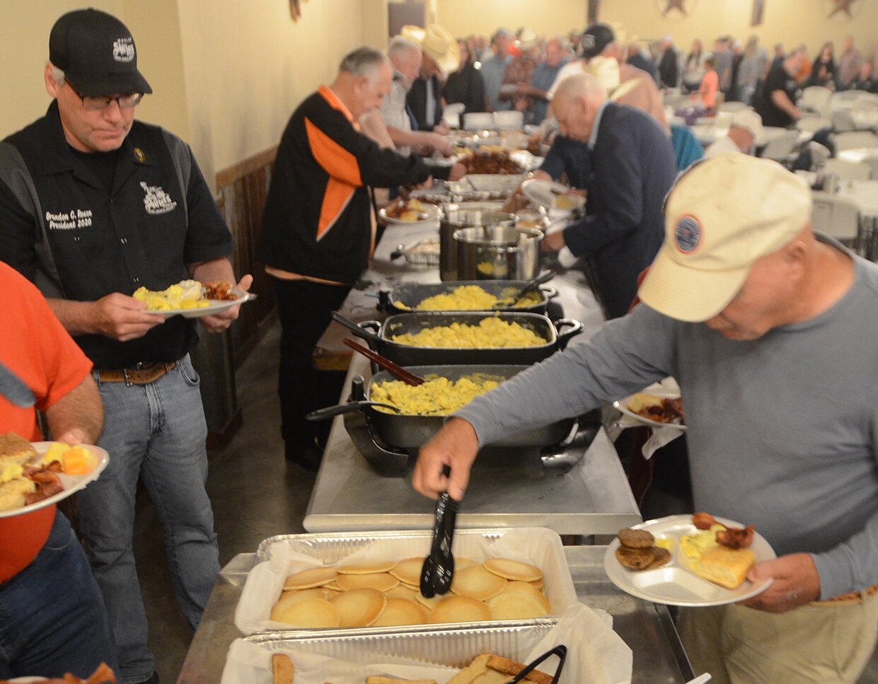 Parker County Cowboy Church members and guests enjoy 40 feet of food at the annual Men’s and Women’s Ironman Breakfast.
