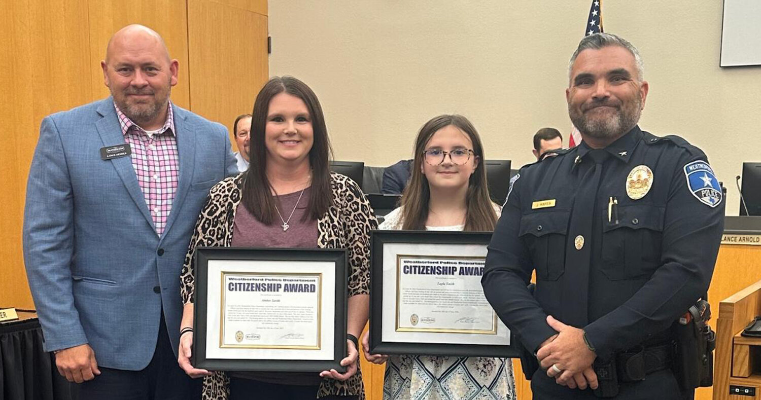Amber Smith and her daughter, Layla, received the citizenship award from Weatherford Police Department Commander Jason Hayes for helping the department find a missing person. Shown are (from left) Weatherford Police Department Chief Lance Arnold, Amber Smith, Layla Smith, and Hayes.