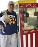 Dr. Don Newbury, a 50-year Popcorn Tradition, shown with 4th machine and rescue dog Archie.