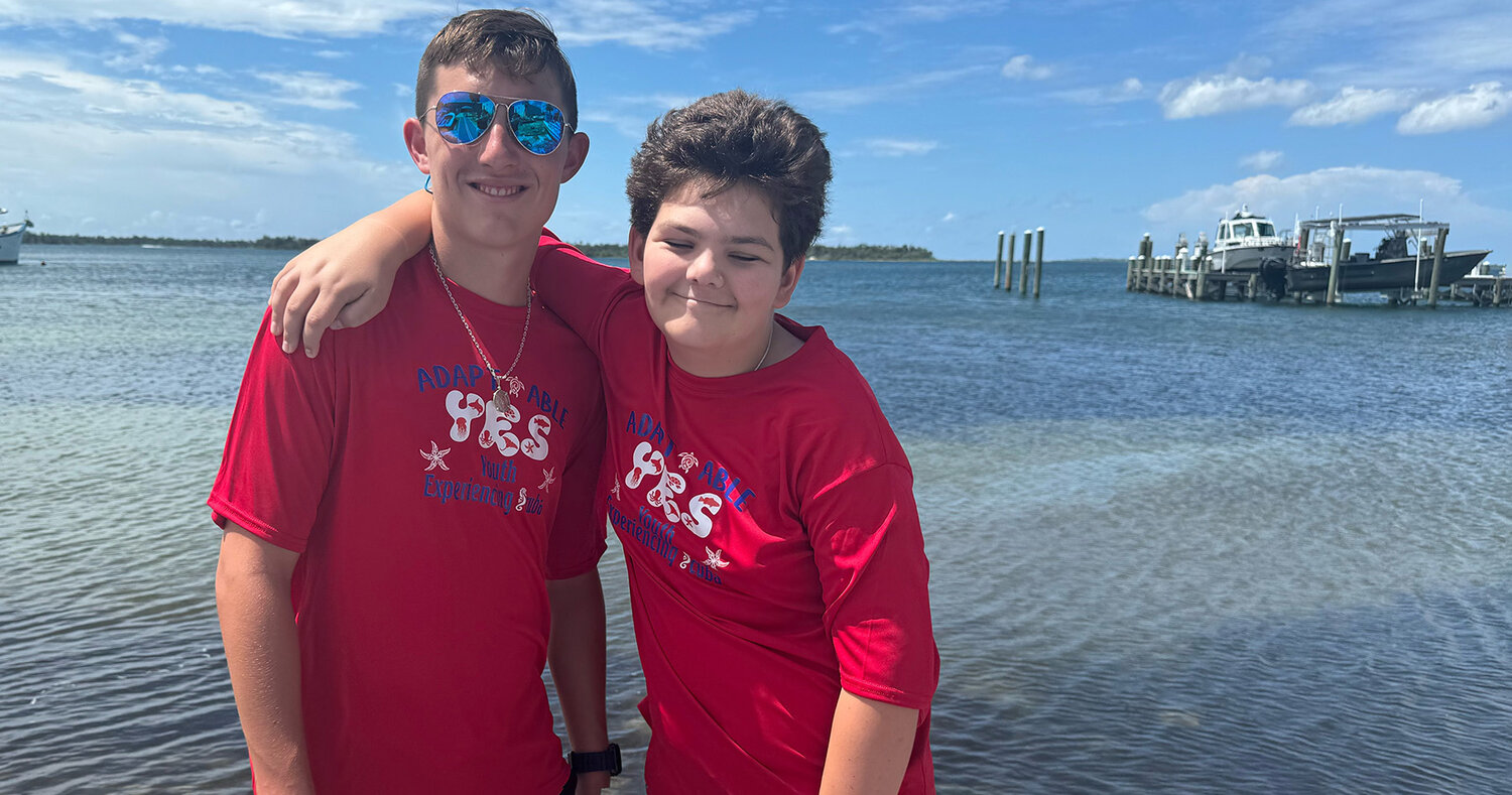 Aledo swimmer Jaxon Robinson (left)  is shown with his cousin Jacob Kiser. Jaxon and his dad, Jason, spent a week in Orlando this summer helping special needs swimmers and divers with certification, which included his cousin (right).