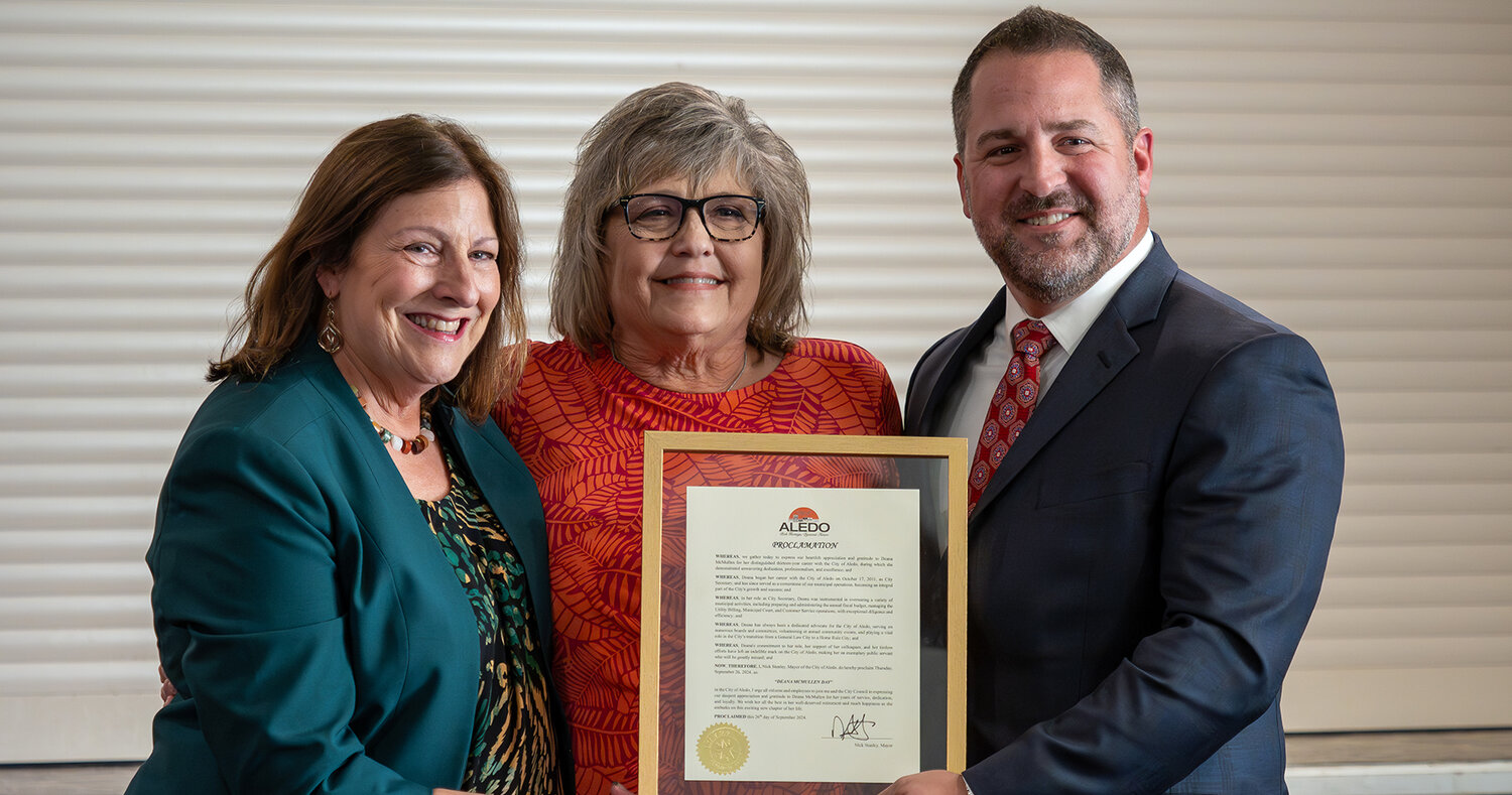 Aledo mayor Nick Stanley and former mayor Kit Marshall pose for a photo with Deana McMullen on Thursay, Sept. 26. McMullen officially retired as City Secretary after 13 years with the City of Aledo.