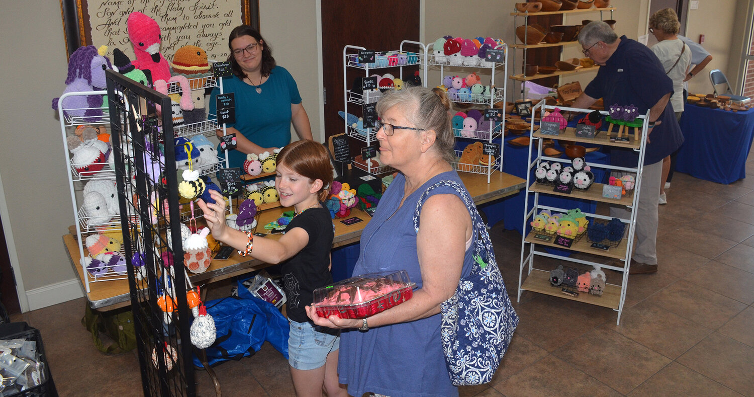 Kinley Morrow shops one of the booths at Aledo Methodist Church Lord's Acre with grandmother, Joyce Echstein.