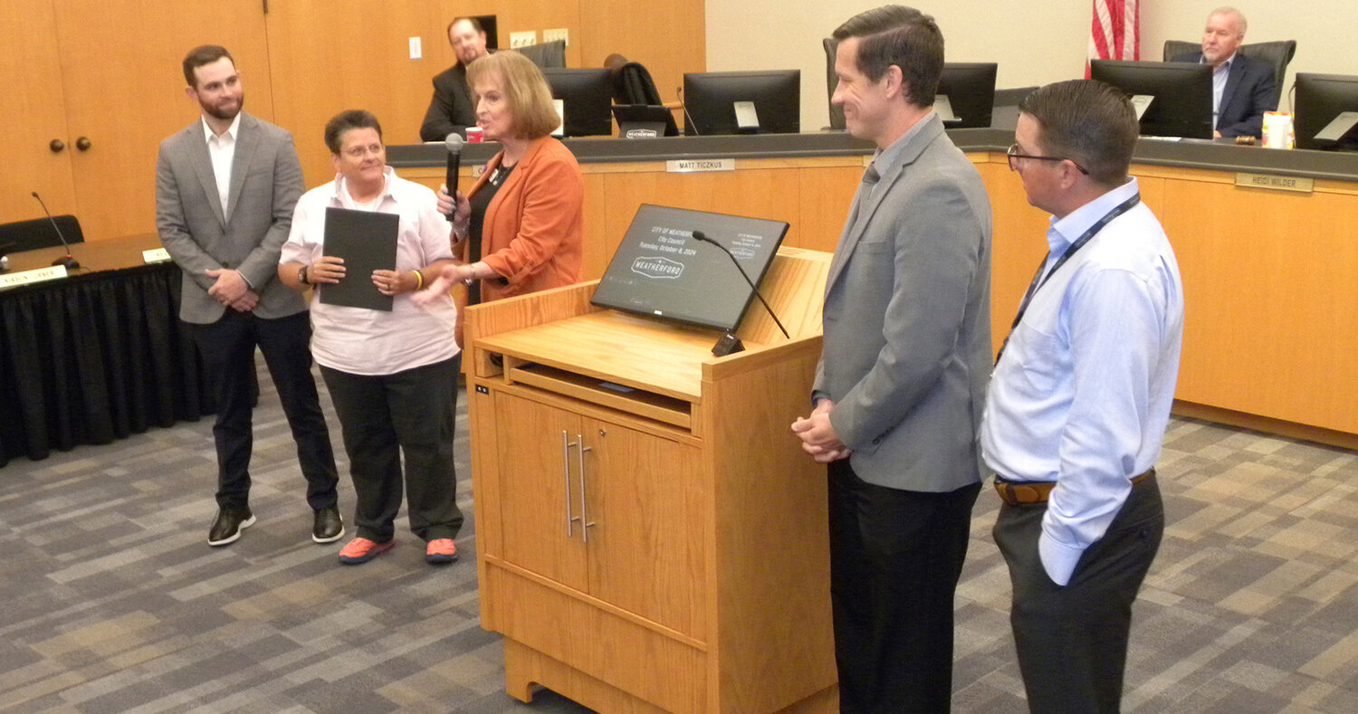 Debbie Buckman of Freedom House of Parker County, center, expresses gratitude for the council declaring October Domestic Violence Awareness Month. Presenting the declaration are Luke Williams, Place 4, Heidi Wilder, Place 1 and Mayor Pro Tem, Matt Ticzkus, Place 3 and Zack Smith, Place 2..Christopher Amos/The Weatherford News