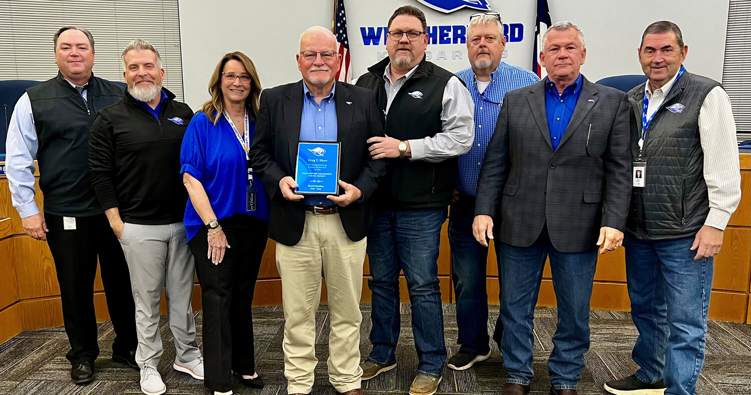 Greg Shaw, center, has resigned from The Weatherford ISD Board of Trustees due to a change in residency. He is shown with (from left) Weatherford ISD Superintendent Beau Rees and fellow board members Adam Feriend, Kindra Lucia, Board President Mike Guest, Jeff Ford, Brian Catlin, and Wally Wallace.