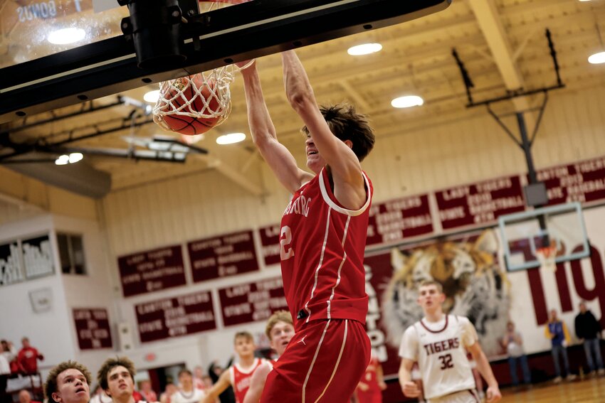 Harrisburg senior Trace Combs jams in a two-handed dunk in the first quarter.