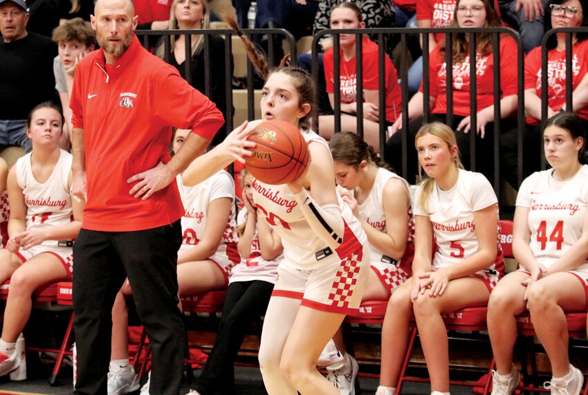 Harrisburg coach Jaryt Hunziker watches as senior Avelina McKinzie shoots a 3-pointer in the second half.