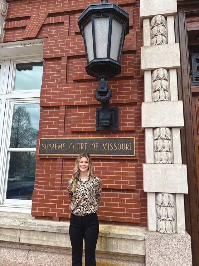 Fayette High School junior Chloe Bier poses before the Missouri Supreme Court building in Jefferson City during Student Government Day in Jefferson City sponsored by the Rotary Club.