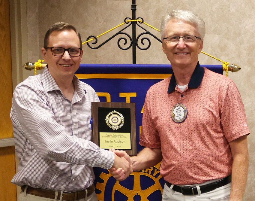 Fayette Advertiser Editor/Publisher Justin Addison (left) accepts the award from Rotary member Jamie Page.