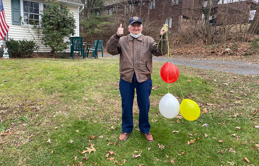 Former Walden Jewish Community Center President Sam Liebman holds balloons after his farewell drive-by event. After approximately 50 years of living in Walden, he has relocated to the Finger Lakes Region.