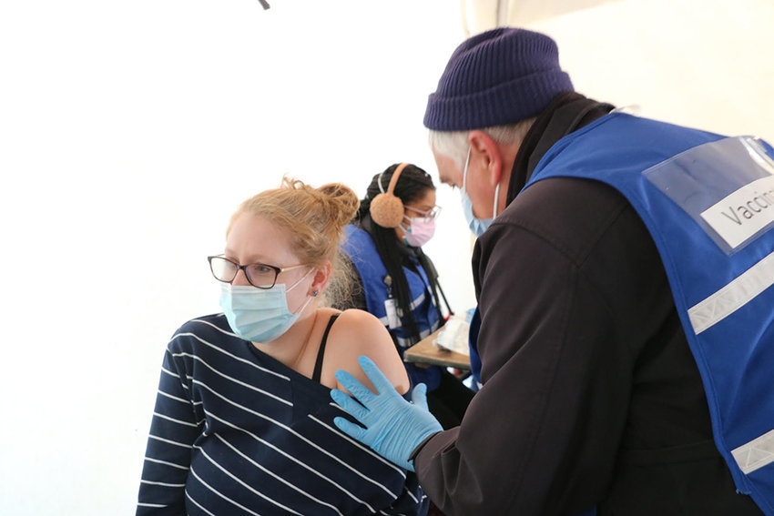 Randy Morse, a Registered Nurse with the Orange County Medical Reserve Corps, administers a vaccine to Elizabeth Black of the City of Newburgh, a preschool teacher.