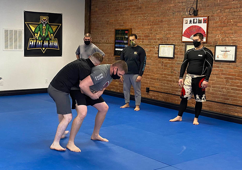 Mike Smith (left), a police officer in Rockland County, exhibits a takedown during a demonstration of the Town of Montgomery Police Department&rsquo;s defense tactics training course on Thursday at Fat Cat Jiu Jitsu.