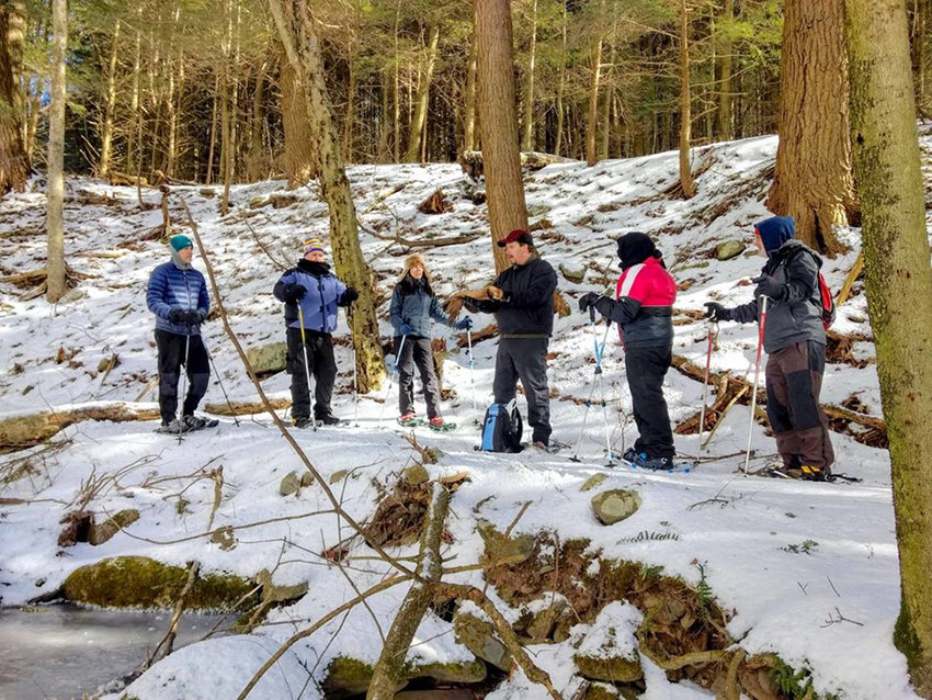 Participants enjoy a guided stream walk on snowshoes along Birch Creek in February 2020.