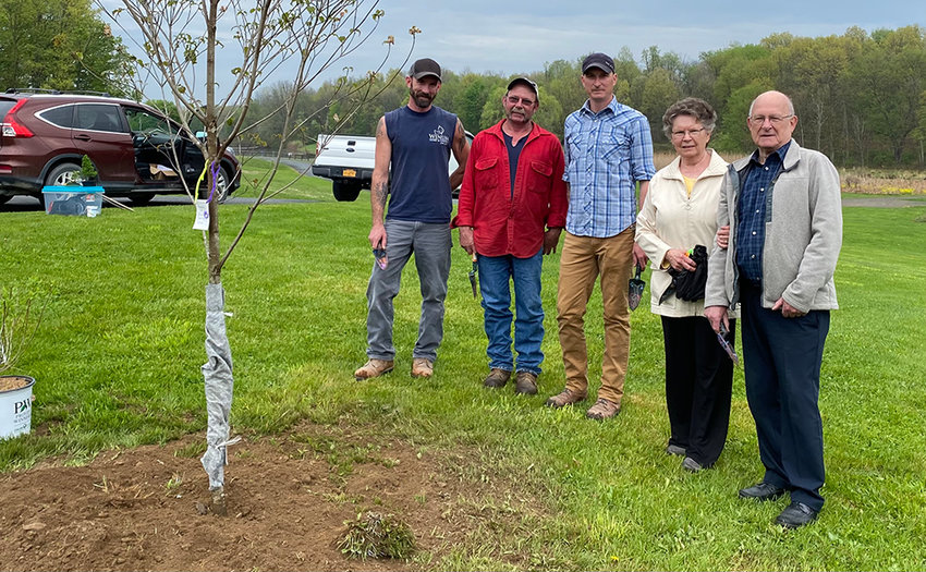 The Winum family pose next to the tree dedicated to their family member Police Officer Dominic Winum, who was killed serving in the line of duty. From left to right: Karl Winum, Nat Winum, Brant Winum, Dominic&rsquo;s mother Jean Winum and Dominic&rsquo;s father Larry Winum.