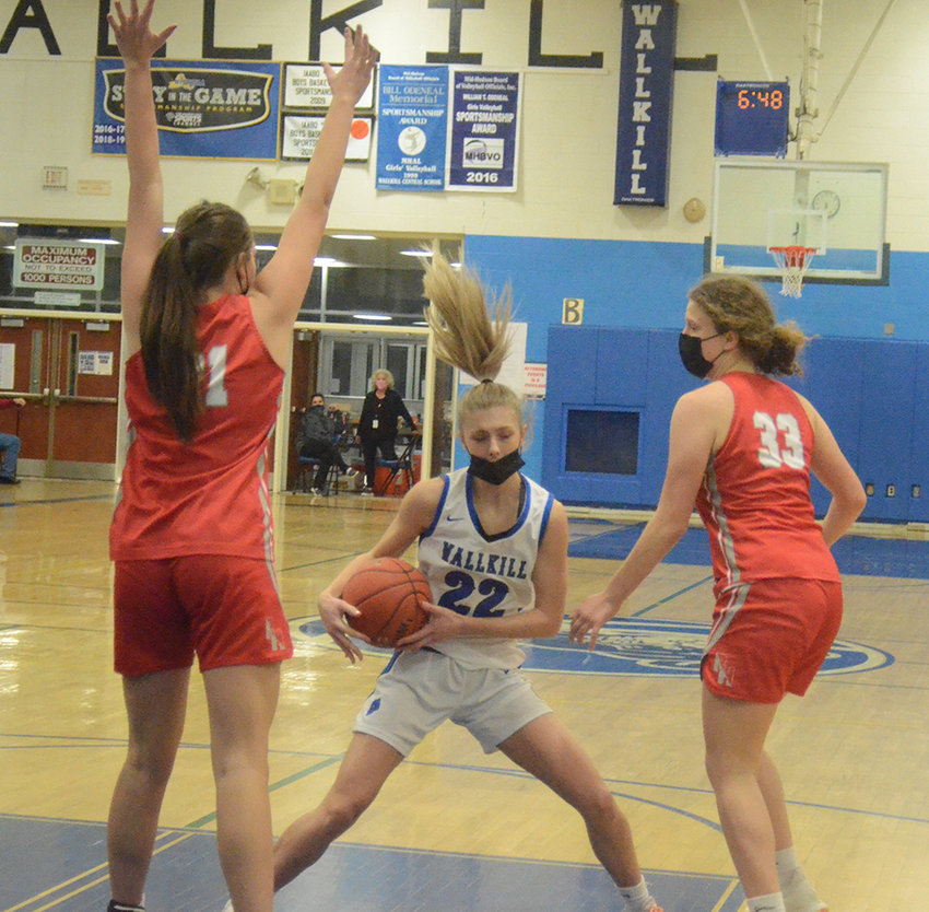 Wallkill&rsquo;s Emma Spindler comes down with the basketball as Red Hook&rsquo;s Emilie Kent (21) and Stellah LeGendre (33) defend during Thursday&rsquo;s Coaches Vs. Cancer championship girls&rsquo; basketball game at Wallkill Senior High School.