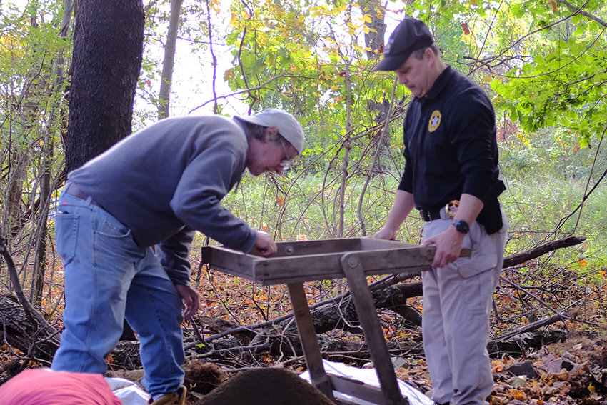 SUNY New Paltz Professor Joseph Diamond [l] looks over soil for artifacts that Lloyd Police Chief James Janso has sifted a number of times.