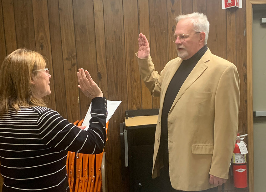 George Hickey is sworn in as a new member of the Plattekill Planning Board by Town Clerk Donna Hedrick.