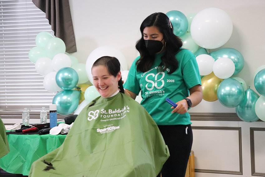 Cynthia Espire shaves the head of Leanne Keator at Saturday&rsquo;s St. Baldrick&rsquo;s event.