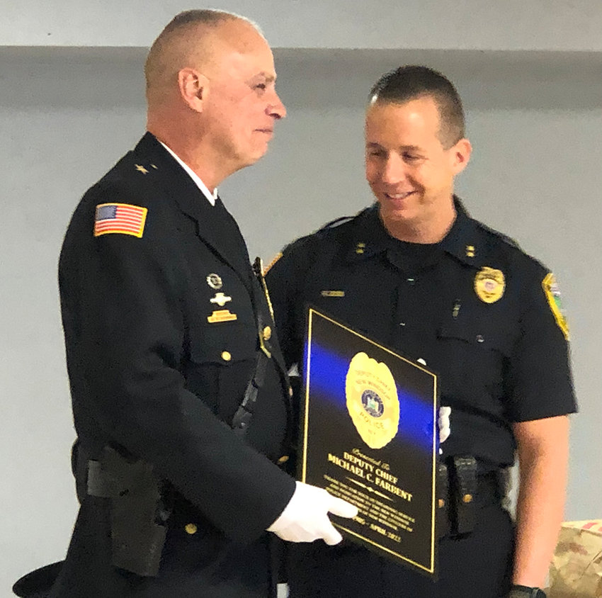 New Windsor Police Chief Robert Doss presents Deputy Chief Michael C. Farbent a plaque commemorating and thanking Farbent for his 37 years of service to the town.