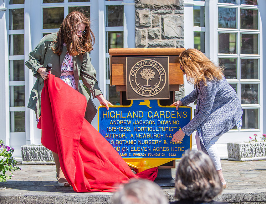 Orange County Historian Johanna Porr-Yaun (l) and Joan Porr unveil the Pomeroy Historic Marker for Highland Gardens, the home and nursery lands of Andrew Jackson Downing.