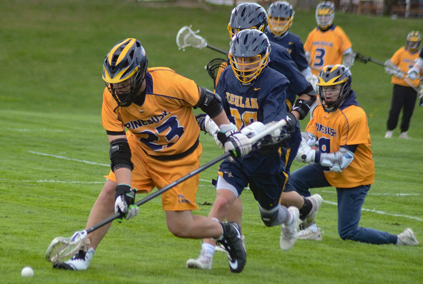 Pine Bush&rsquo;s Nickolas Zwart scoops up the ball as Highland&rsquo;s A.J. Palmer trails the play during Wednesday&rsquo;s boys&rsquo; lacrosse game at Pine Bush Elementary School.