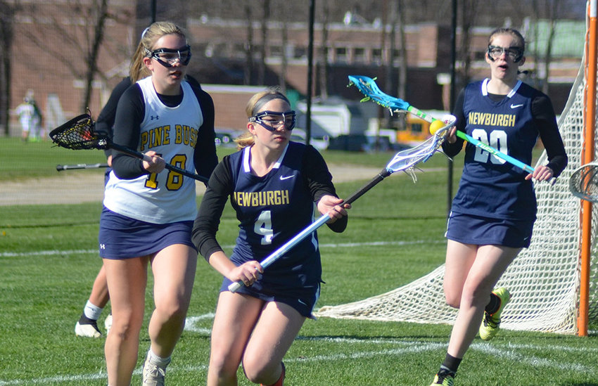 Newburgh&rsquo;s Malia Robinson takes the ball out of the Goldbacks&rsquo; defensive zone as Pine Bush&rsquo;s Brigid Boyle (18) trails the play to defend during Thursday&rsquo;s girls&rsquo; lacrosse game at Pine Bush Elementary School.