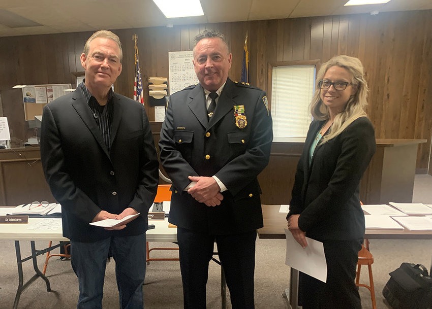 John Mulrooney (left) and Nicole Brooks flank Town of Plattekill Police Chief Joseph Ryan after being sworn in as new officers at the May 4 Town Board meeting.