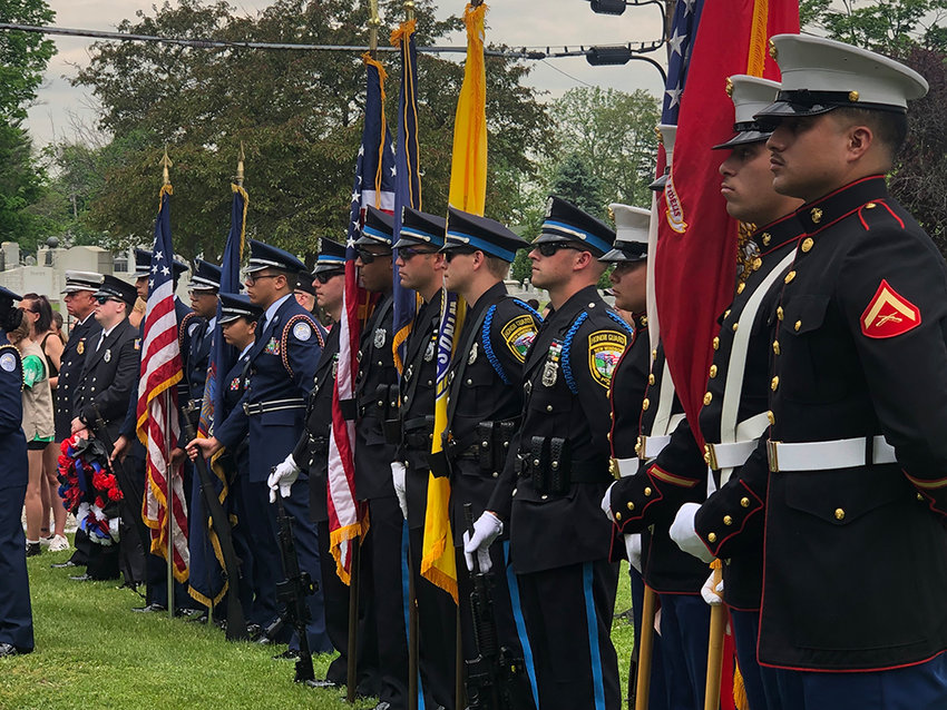[L-R] Newburgh Free Academy Air Force Junior Reserve Officers Training Corps cadets, New Windsor Police Department officers, and United States Marine Corps officers stand at ease with the colors.