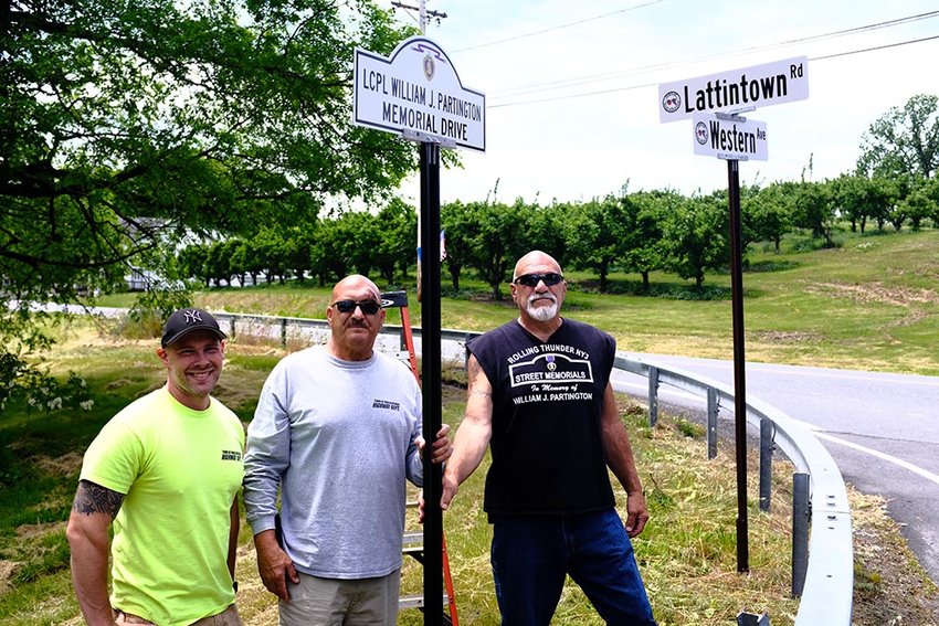 New street signs honoring those who were killed in action are being erected in Lloyd and Marlborough. Pictured (l. &ndash;r.)are Marlborough Highway employee Don Cosman, Marlborough Highway Superintendent John Alonge and Rolling Thunder member Charley Alonge erecting a sign in honor of LCPL William Partington at the intersection of Western Avenue and Lattintown Road in Marlboro.