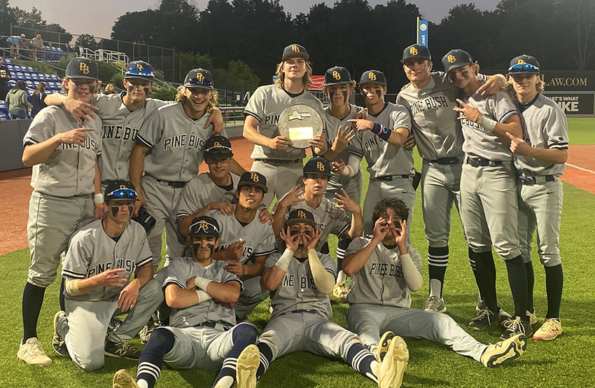 The Pine Bush baseball team poses with the NYSPHSAA Class AA regional plaque after beating Roy C. Ketcham, 8-5, on Saturday at Dutchess Stadium in Fishkill.