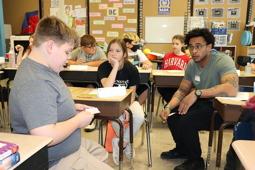 Gabe Swart, a Grade 5 student in Kristen Eckert&rsquo;s class at Highland Elementary School (left), has a discussion with Highland Rotary member Shawn Serafa during a Junior Achievement lesson about entrepreneurship.