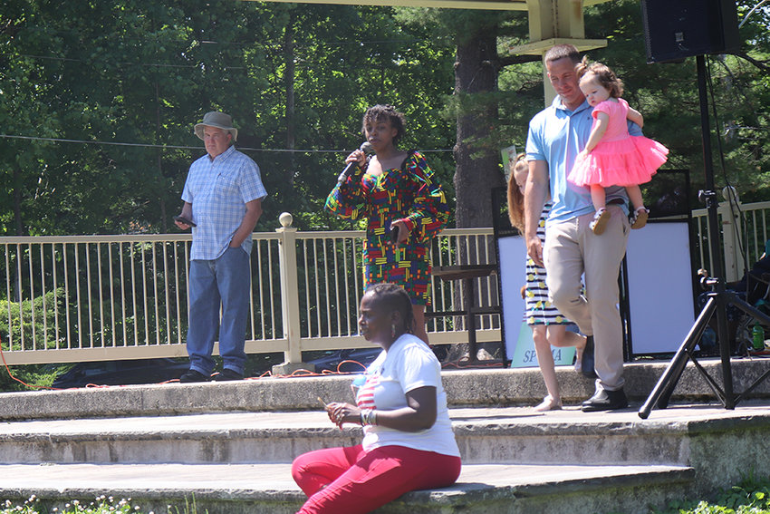 Mercedes Ortiz speaks, as Brian Maher leads his two children offstage at Monday&rsquo;s Juneteenth event in Walden.