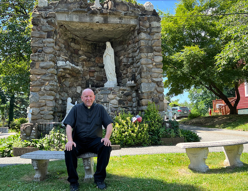 Father Bill Damroth in the prayer garden he created at Saint Francis Church in Newburgh.