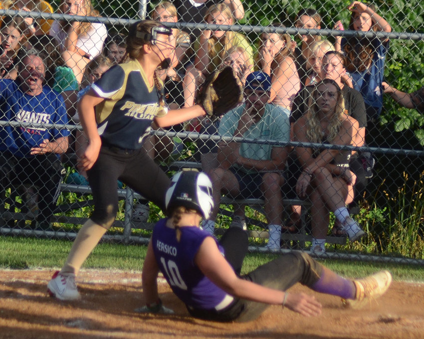 Warwick&rsquo;s Erin Persico slides into home plate as Pine Bush&rsquo;s Courtney Flynn covers home plate during a Majors championship softball game at Memorial Park on June 27 in Warwick.