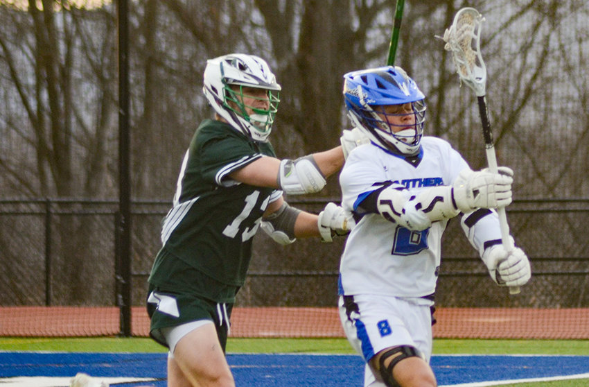 Wallkill&rsquo;s Richie Martinez passes the ball as Minisink Valley&rsquo;s Brandon Truex defends during a non-league boys&rsquo; lacrosse game on March 30 at Wallkill Senior High School.
