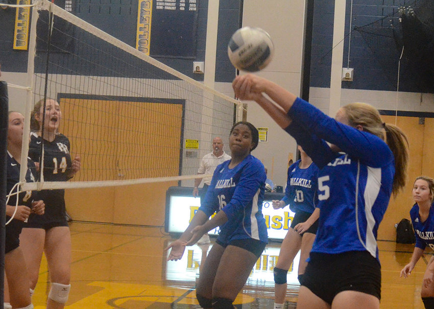 Wallkill&rsquo;s Katelyn Jordy sends the ball back over the net as Wallkill&rsquo;s Madisen Noelizaire (16) looks on.