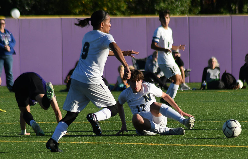 Newburgh&rsquo;s Thomas Koziak makes a sliding tackle to take the ball away from Monroe-Woodbury&rsquo;s Trevor Lagarde as Newburgh&rsquo;s Olvin Flores goes after the ball during Friday&rsquo;s OCIAA Division I boys&rsquo; soccer game at Monroe-Woodbury High School.